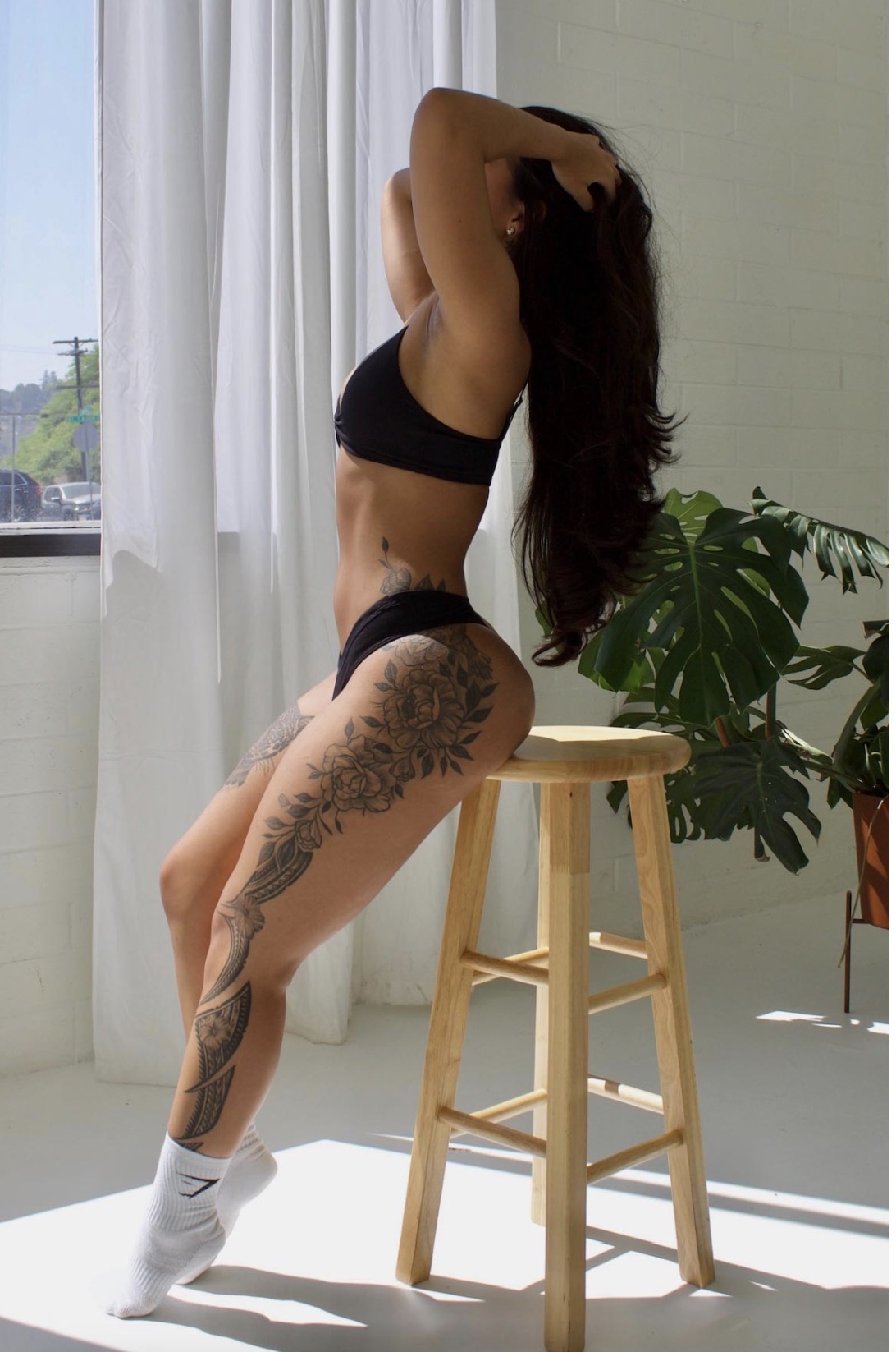 Eva mid-stretch in a warm-lit studio